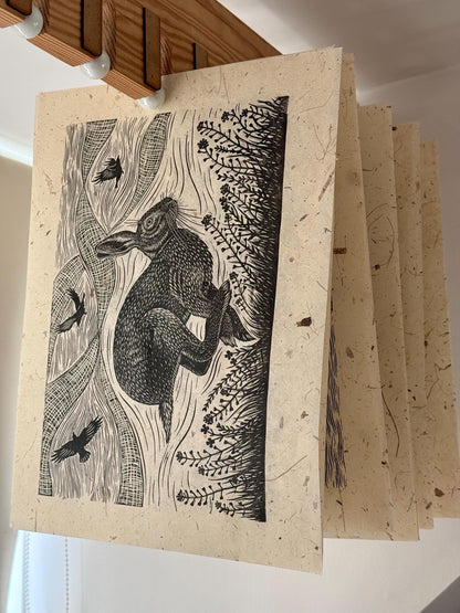 Linocut print of hare and crows